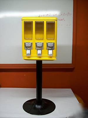 Coin operated 3 compartment vending machines yellow.